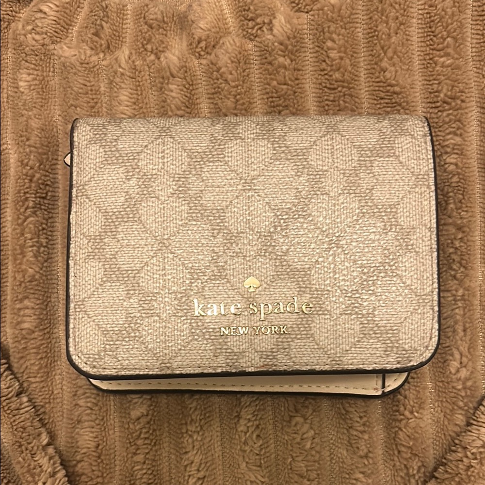 Kate Spade Cream Wallet with Embossed Spade Pattern